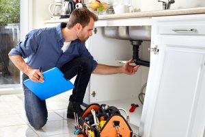plumber checks leaks of a sink drain photo