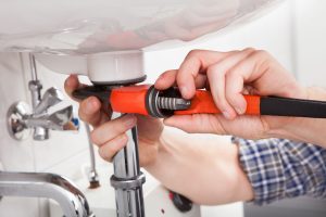 plumber photo while using a wrench
