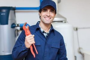 plumber with pipe wrench photo